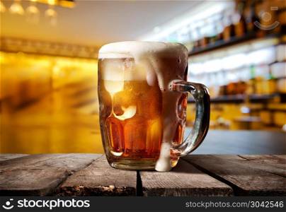 A big glass of beer on counter bar in restaurant . Beautiful beer pub