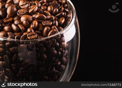 a big jar full of coffee beans, isolated on black background. Copy space. a big jar full of coffee beans, isolated on black with clipping path.