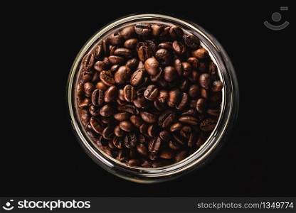 a big jar full of coffee beans, isolated on black background. top view from above. a big jar full of coffee beans, isolated on black with clipping path.