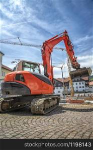 A big red excavator working at the construction site. Vintage view