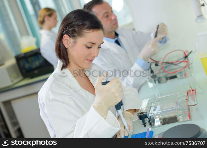 a biological technician putting samples