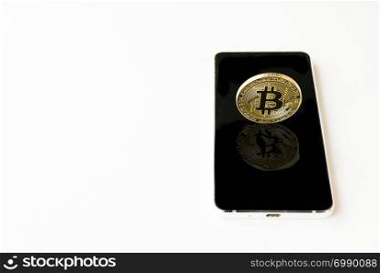 A Bitcoin Cryptocurrency Digital Bit Coin BTC Currency Technology Business Internet Concept. Bitcoin over smartphone