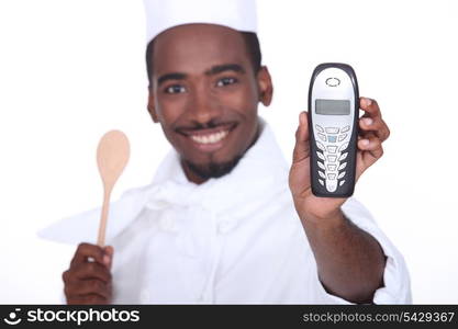 A black chef handing the phone over.