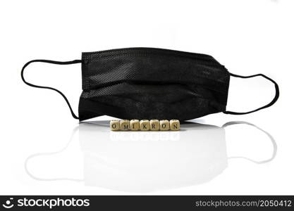 a black face mask used to protect against omicron and corona or covid isolated on white background. a black face mask on white background