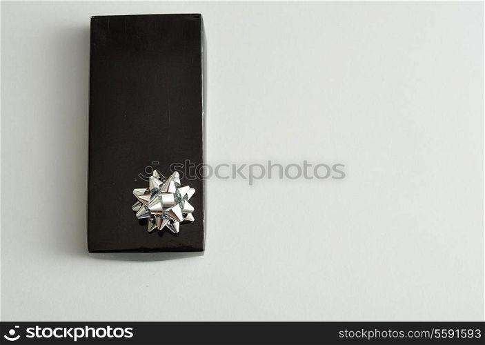 A black gift box with a silver bow isolated on a white background