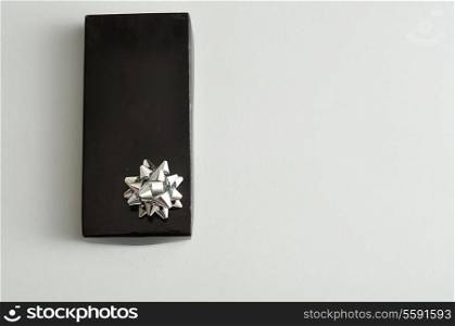 A black gift box with a silver bow isolated on a white background