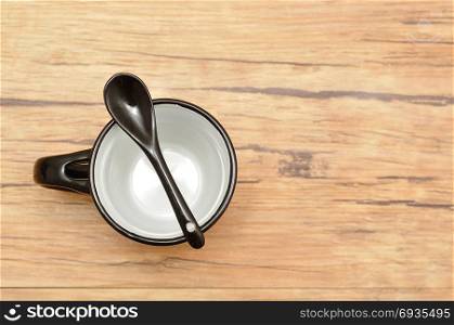 A black mug with a black teaspoon