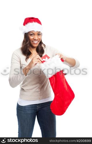 A black woman celebrating christmas picking out gift from stocking