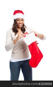 A black woman celebrating christmas picking out gift from stocking