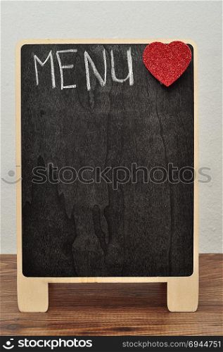 A blackboard with the word menu and a red heart