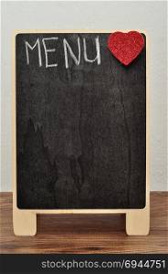 A blackboard with the word menu and a red heart