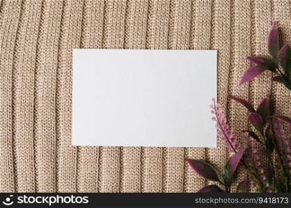 A blank card and a leaf on a sweater