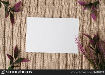 A blank card and a leaf on a sweater
