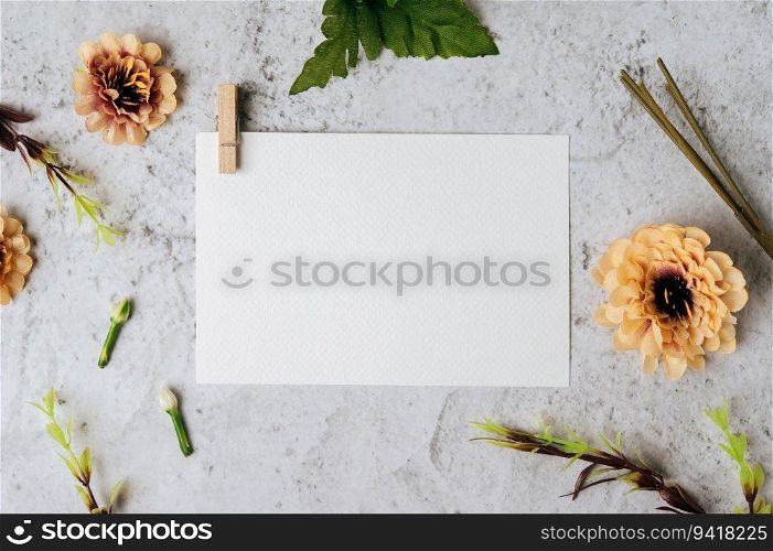 A blank card and flower is placed on white background