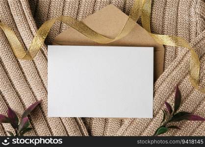 A blank card is placed on envelope and a sweater