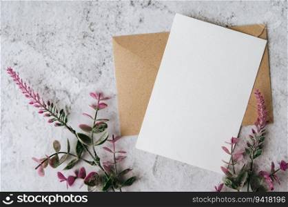 A blank card with envelope and flower is placed on white background
