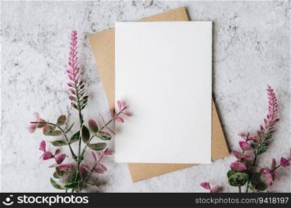 A blank card with envelope and flower is placed on white background