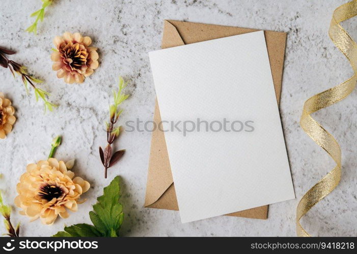 A blank card with envelope and flower is placed on white background