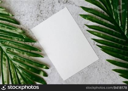 A blank card with envelope and leaf is placed on white background
