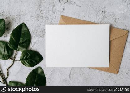 A blank card with envelope and leaf is placed on white background