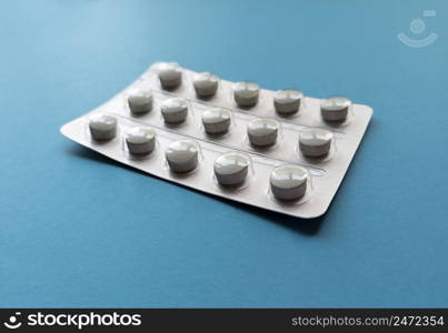 A blister of tablets on blue background. Medical concept. Stock photography.. A blister of tablets on blue background. Medical concept. Stock photo.