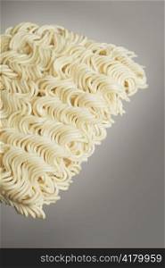 A Block of dried instant ramen noodles in closeup