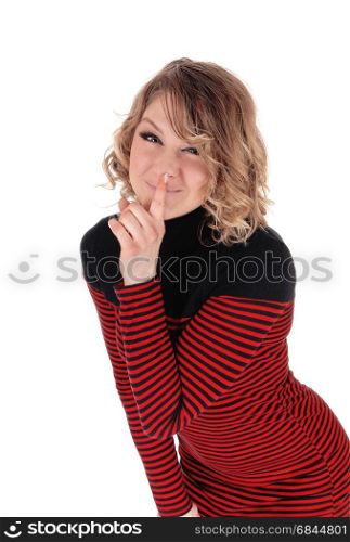 A blond happy woman standing bending forward with her finger overher mouth and smiling, isolated for white background.