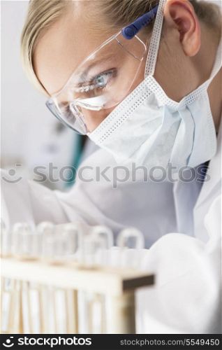 A blond medical or scientific researcher or doctor working in a laboratory
