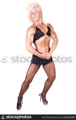 A blond muscular bodybuilding woman standing in the studio shooing her strong legs and the upper body and arms, over white background.