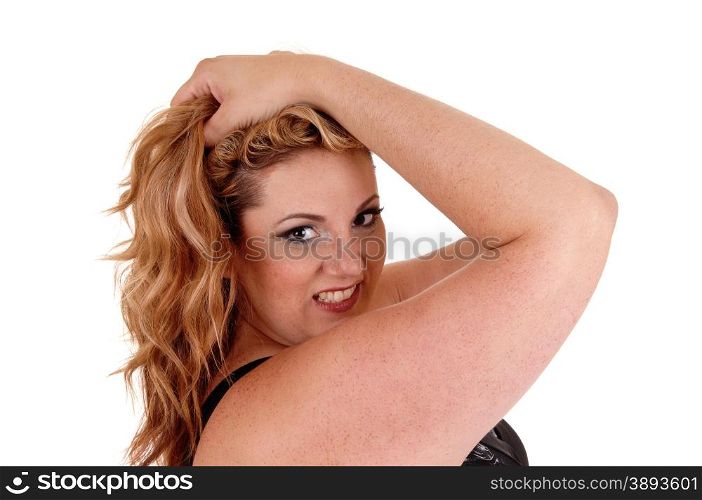 A blond plus size woman holding both her hands on her head and lookinginto the camera, isolated for white background.