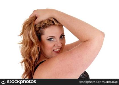 A blond plus size woman holding both her hands on her head and lookinginto the camera, isolated for white background.