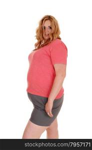 A blond plus size woman standing in shorts and a pink sweater,isolated for white background.