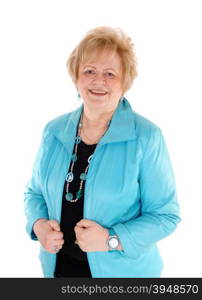 A blond senior woman in a blue jacket, smiling, standing waist up isolatedfor white background.