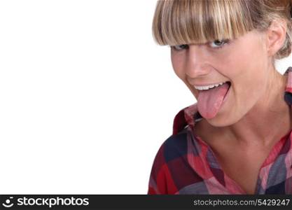A blond teenager pulling her tongue out.