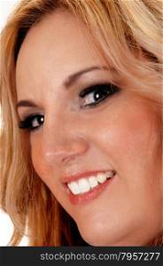 A blond woman in a closeup face picture looking, smilinginto the camera, isolated for white background.