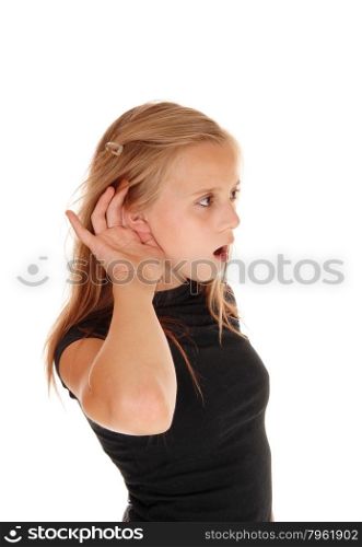 A blond young girl in a black top with one hand behind her ear can nothear well, isolated for white background.