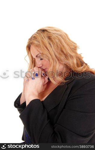 A blond young plus size women in profile with her hands folded, praying,isolated for white background.