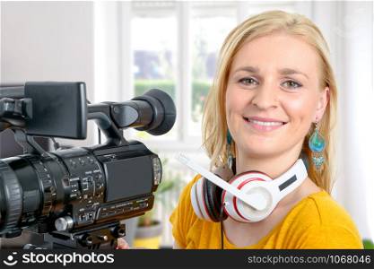 a blond young woman with professional video camera