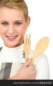 a blonde woman with wooden flatware