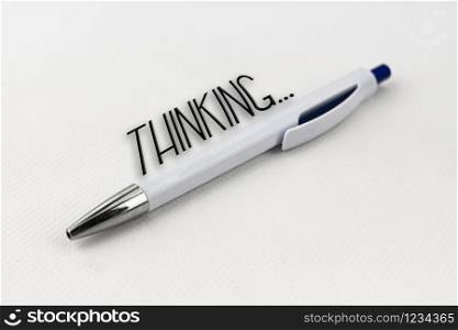A blue and white pen with silver tip on white background
