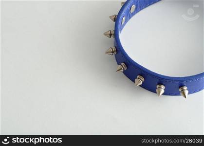A blue dog collar decorated with spikes