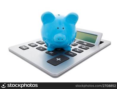 A blue piggy bank sitting on a large calculator. Conceptual savings. Isolated with clipping path.