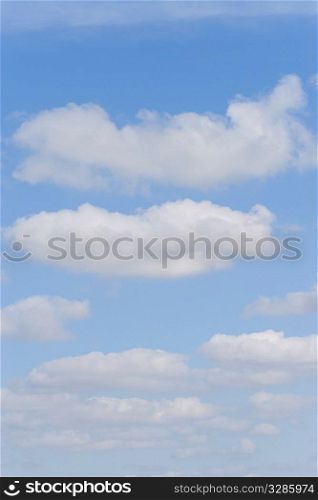 A blue sky filled with perfect fluffy cumulus clouds