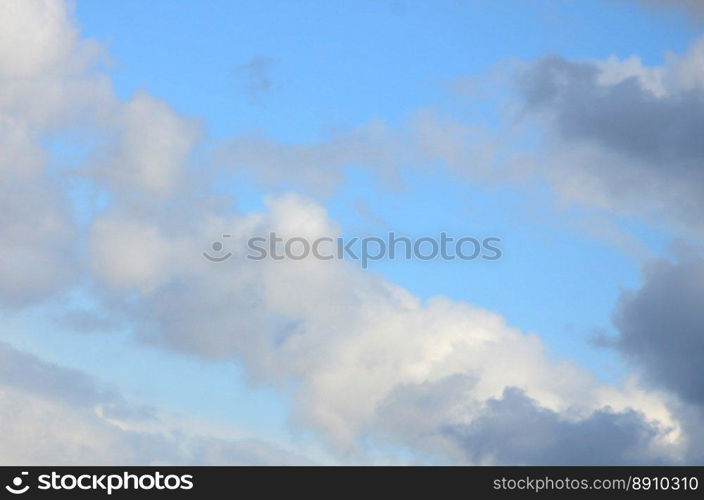 A blue sky with lots of white clouds of different sizes