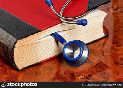 a blue stethoscope liegtn in a medical book