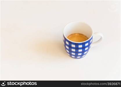 a blue striped cup of coffee