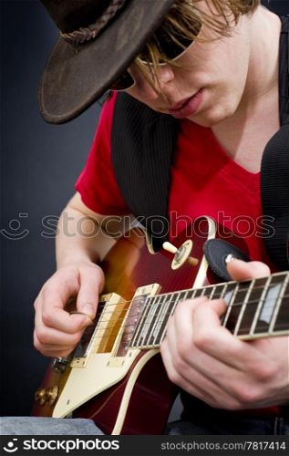 A blues guitarist playing a tune on his instrument
