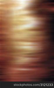 A blurred abstract background of warm brown and tan tones.