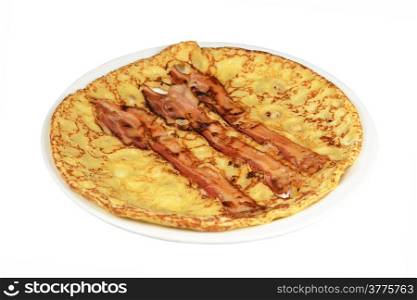 A board with a pancake with bacon strips on a white background.