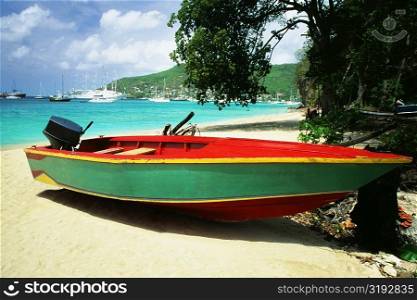 A boat is seen on a seashore on a sunny day, The Grenadines